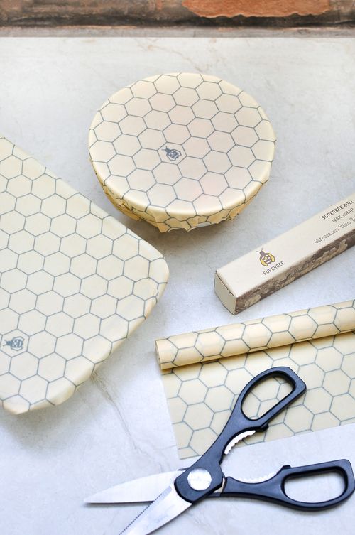A honeycomb beeswax wrap roll with cut pieces and scissors laid out