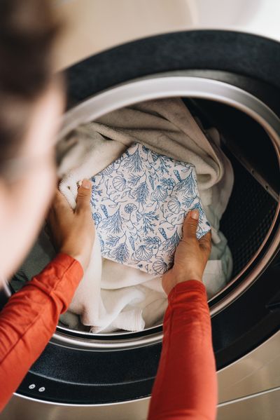 Hexawash pouch going into a washing machine drum