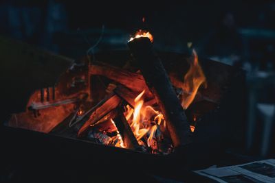 A campfire burning down to embers in the dark