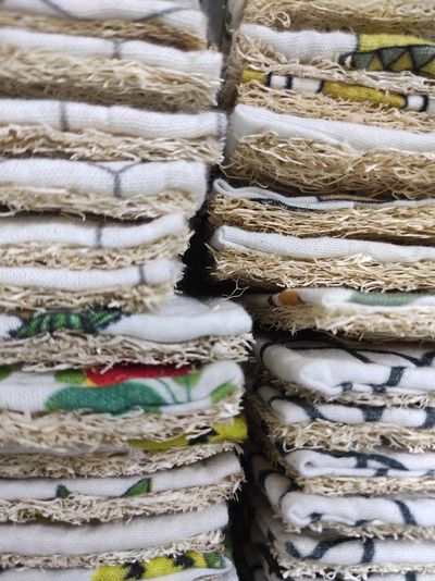 A tall stack of SuperBee natural loofah dish scrubbers