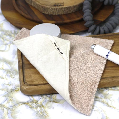 SuperBee reusable kitchen cloths folded on a serving board