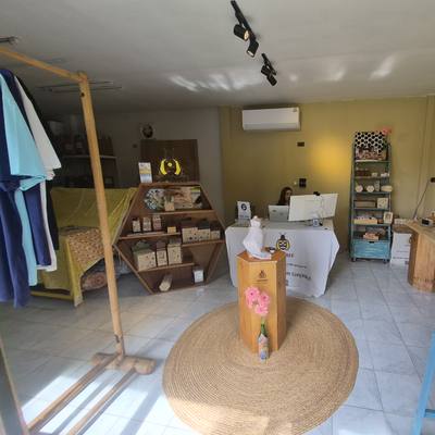 Inside the showroom: the display tables, the wrap stand and the rattan rug