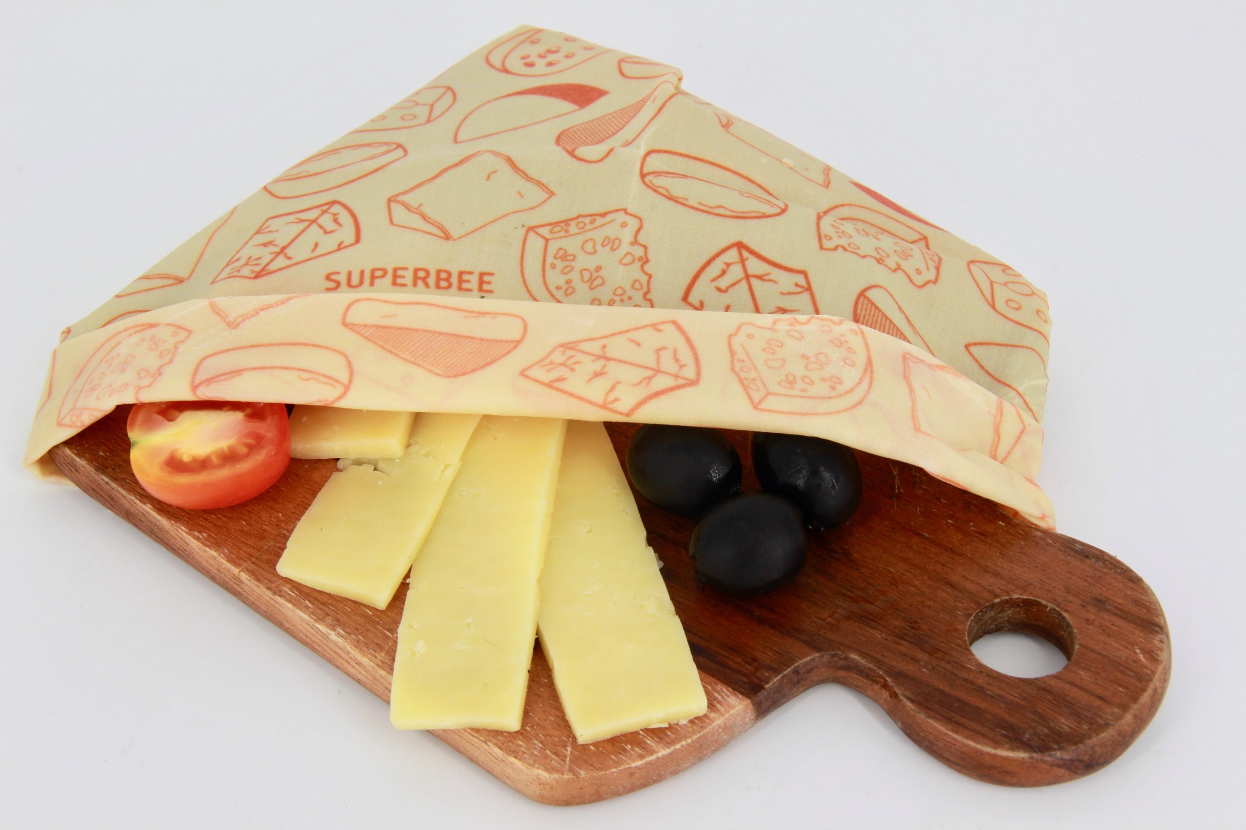 Wedge of cheese stored without plastic in a SuperBee beeswax wrap